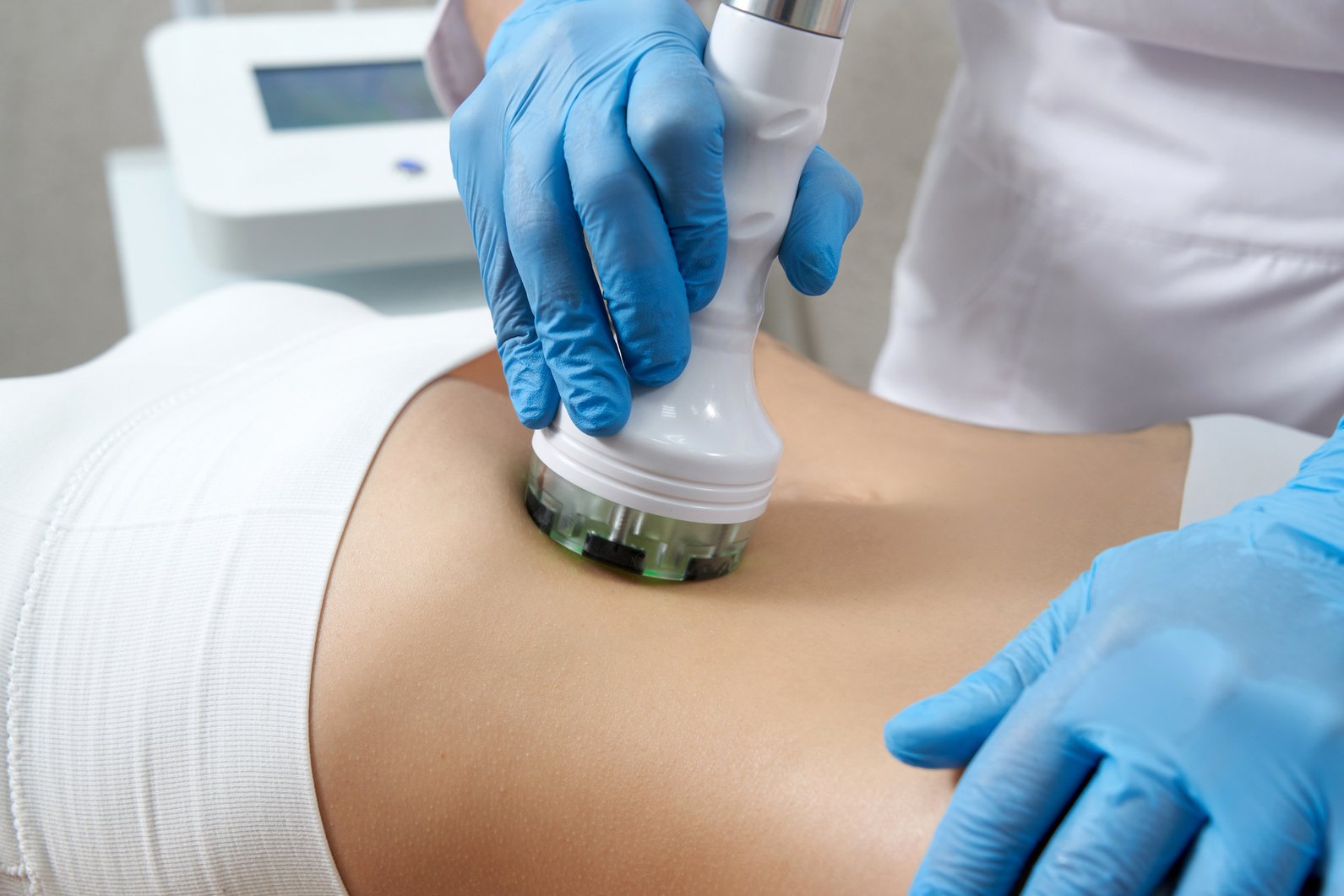 Gloved Hand Holding a Sculpting Machine on a Stomach